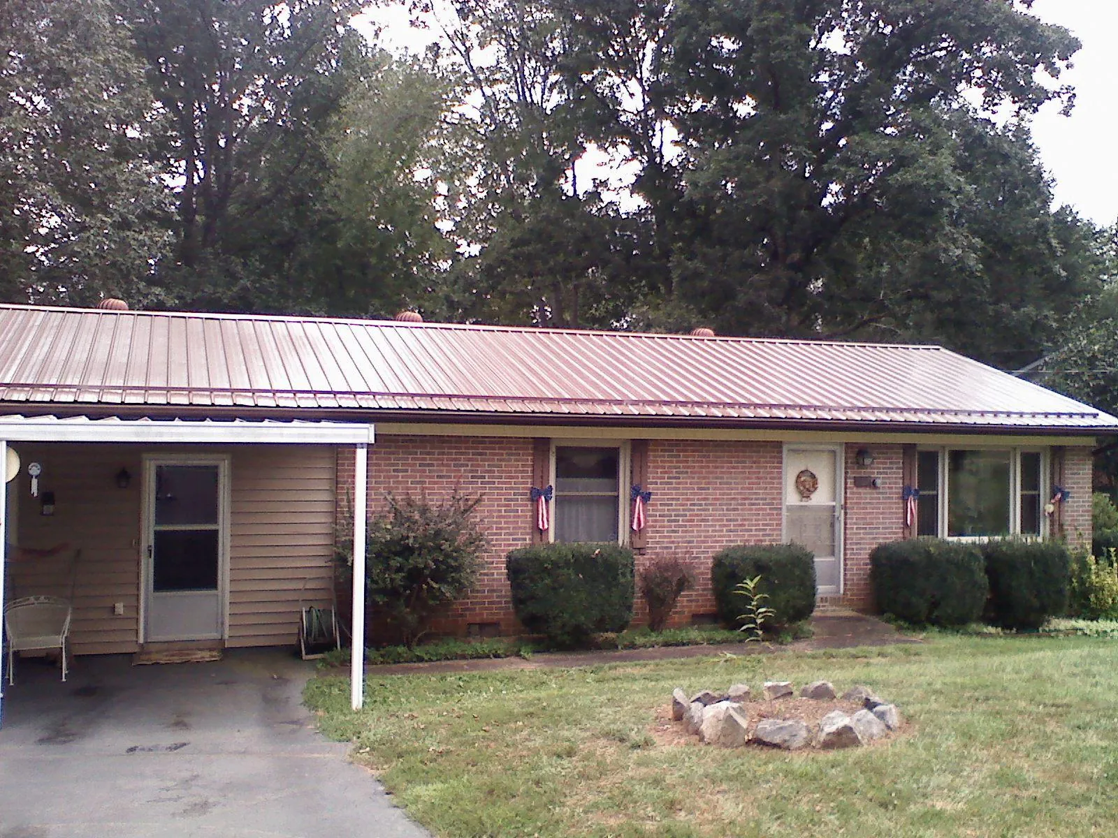 Bronze metal roof and carport on a brick ranch home — Roof Repair work by our crew in Ashland City